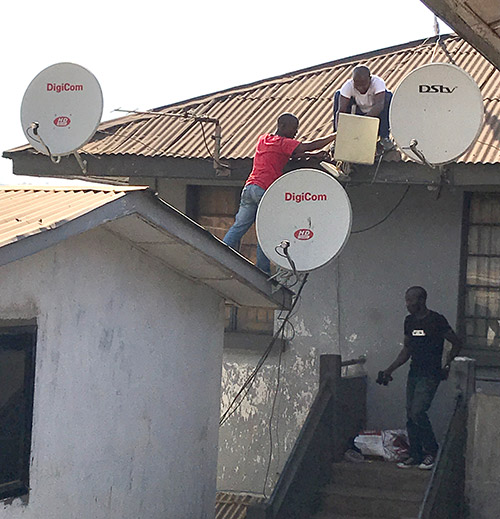 Technicians check satellite broadcast equipment